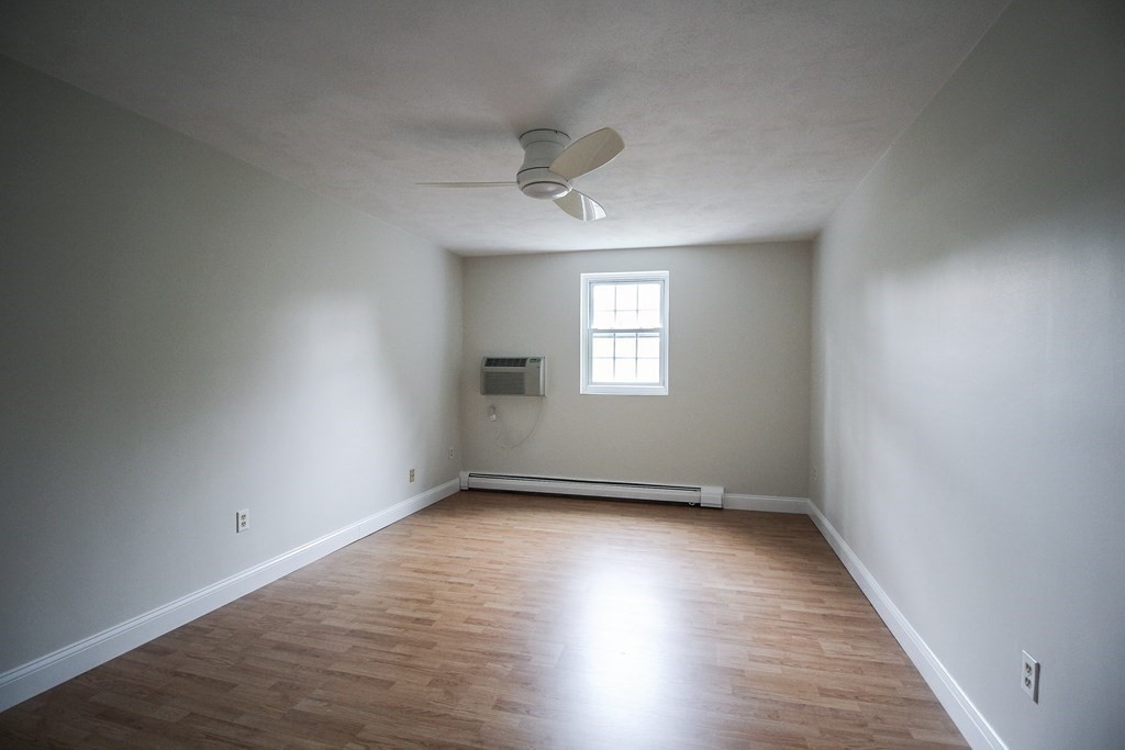 272 Albion Street, Unit 23 Wakefield, MA 01880 - Photo 22 of 33 a view of an empty room with wooden floor and a window