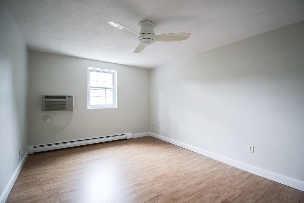272 Albion Street, Unit 23 Wakefield, MA 01880 - Photo 23 of 33 wooden floor in an empty room with a window