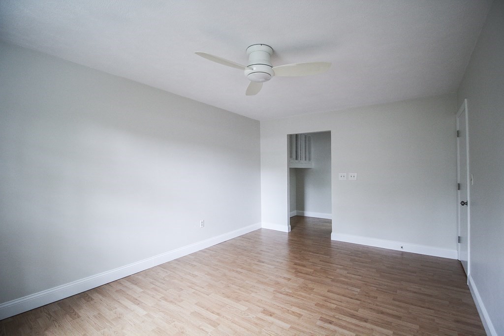 272 Albion Street, Unit 23 Wakefield, MA 01880 - Photo 24 of 33 a view of an empty room with wooden floor and a window