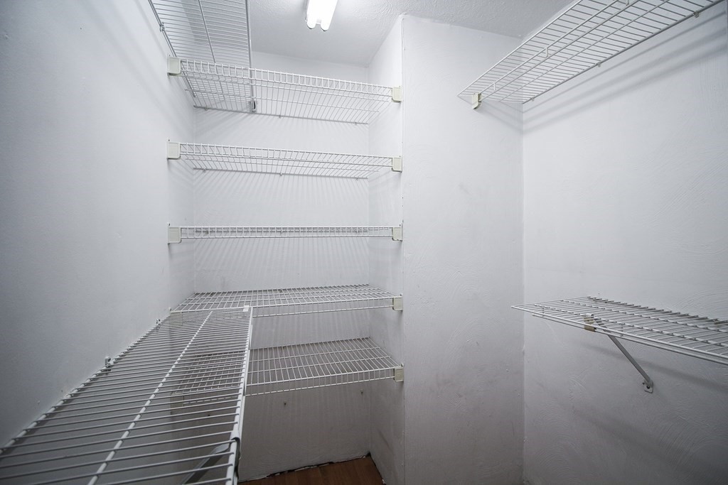 272 Albion Street, Unit 23 Wakefield, MA 01880 - Photo 26 of 33 a walk in closet with wooden floor