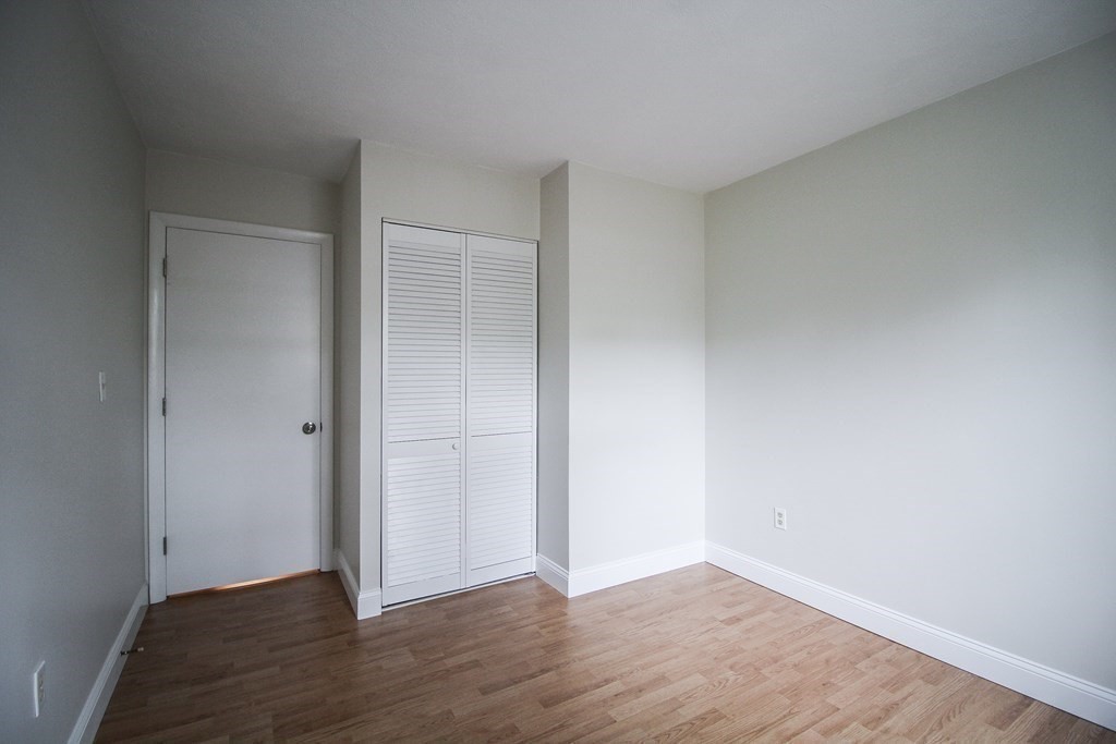 272 Albion Street, Unit 23 Wakefield, MA 01880 - Photo 28 of 33 a view of an empty room with wooden floor