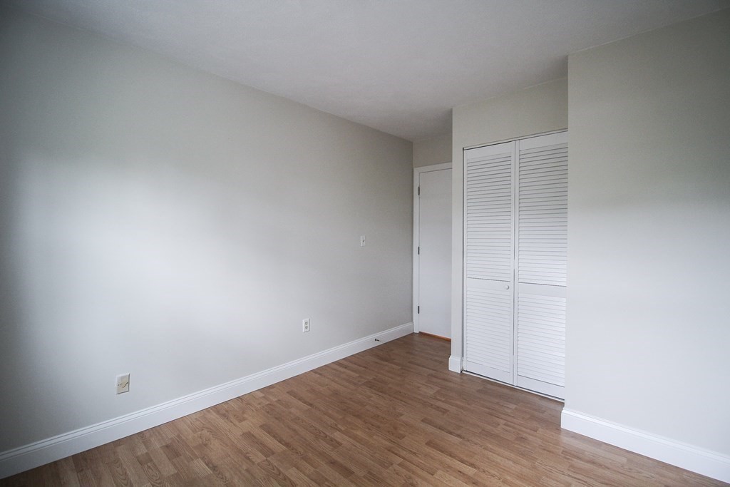 272 Albion Street, Unit 23 Wakefield, MA 01880 - Photo 29 of 33 a view of an empty room with wooden floor