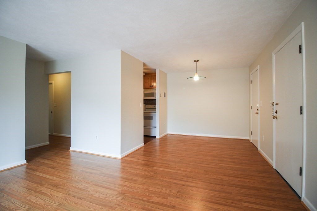 272 Albion Street, Unit 23 Wakefield, MA 01880 - Photo 8 of 33 a view of empty room with wooden floor