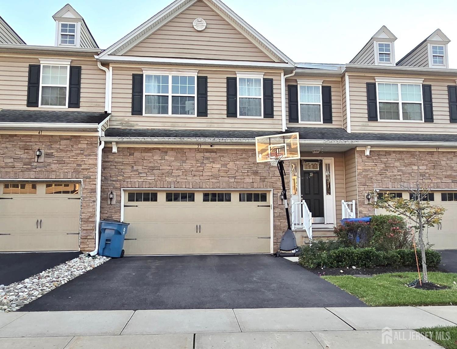 39 Periwinkle Drive, Unit 9 Monroe Township, NJ 08831 - Photo 1 of 26 front view of a house with a yard