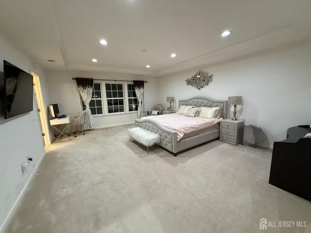 a spacious bedroom with a bed and furniture