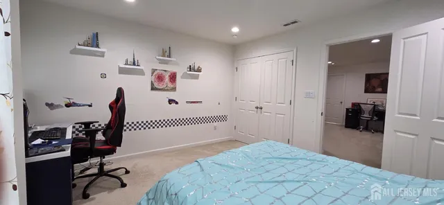 a bedroom with a bed and a view of bathroom