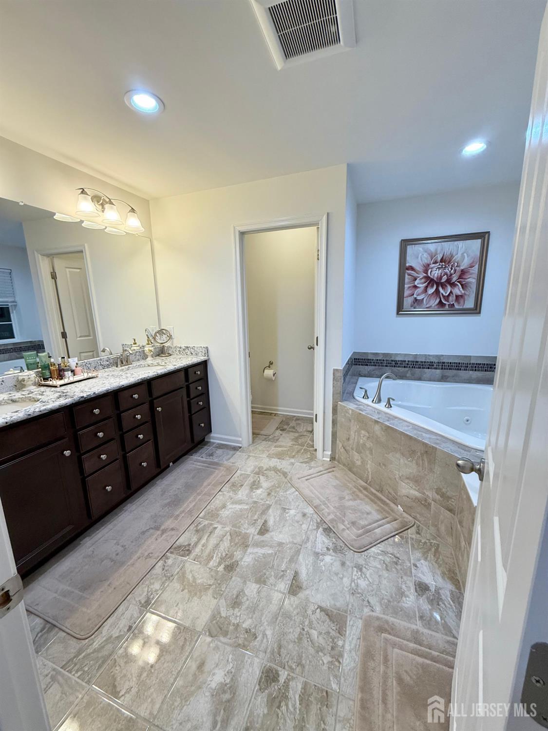 39 Periwinkle Drive, Unit 9 Monroe Township, NJ 08831 - Photo 13 of 26 a spacious bathroom with a double vanity sink and a mirror