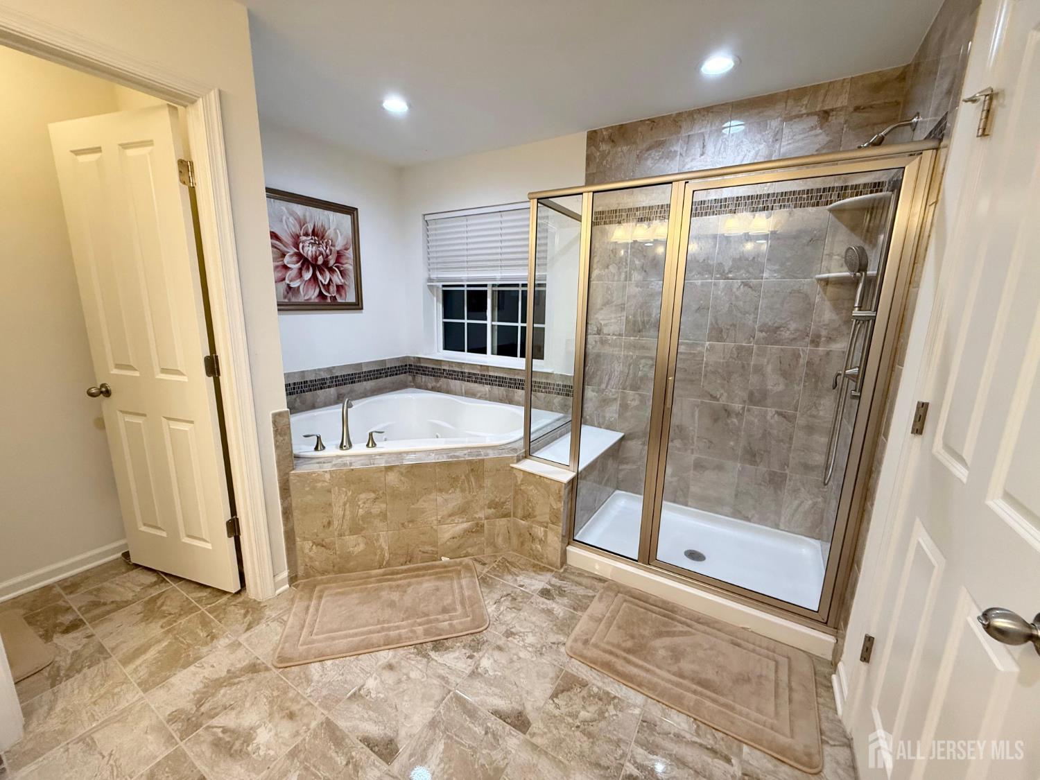 39 Periwinkle Drive, Unit 9 Monroe Township, NJ 08831 - Photo 14 of 26 a bathroom with a tub and shower