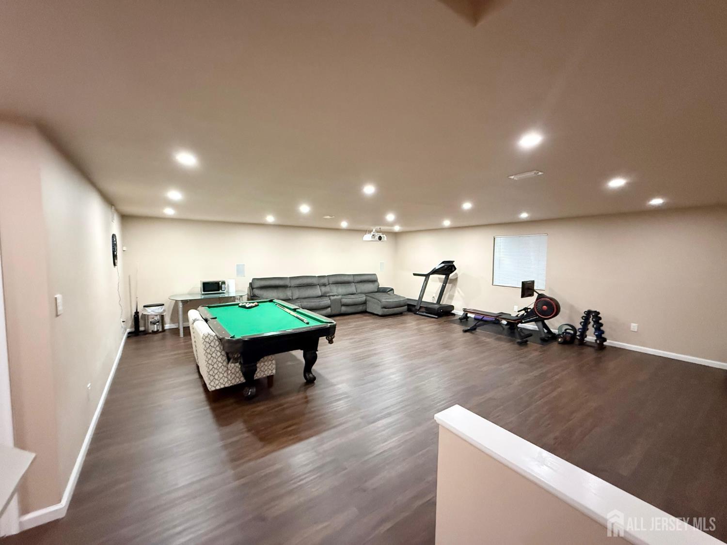 39 Periwinkle Drive, Unit 9 Monroe Township, NJ 08831 - Photo 21 of 26 a room with furniture and a wooden floor