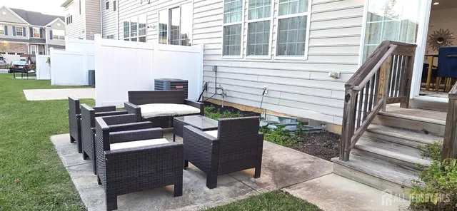 a view of a patio with a table and chairs