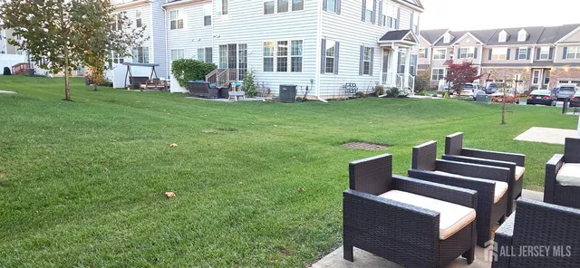 a view of a house with backyard sitting area and garden