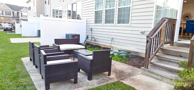 a view of a patio with table and chairs