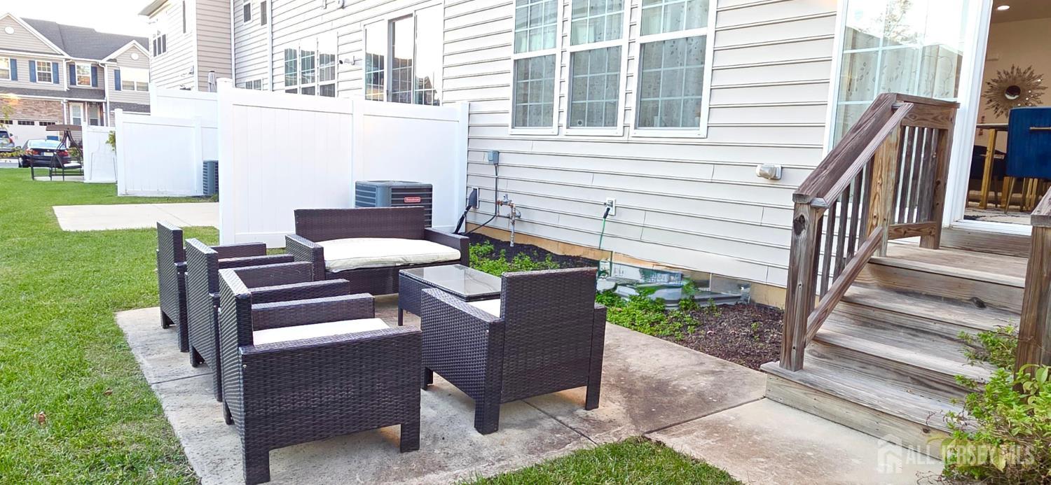 39 Periwinkle Drive, Unit 9 Monroe Township, NJ 08831 - Photo 24 of 26 a view of a patio with table and chairs