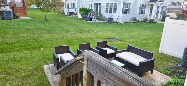 a view of an house with backyard and sitting area