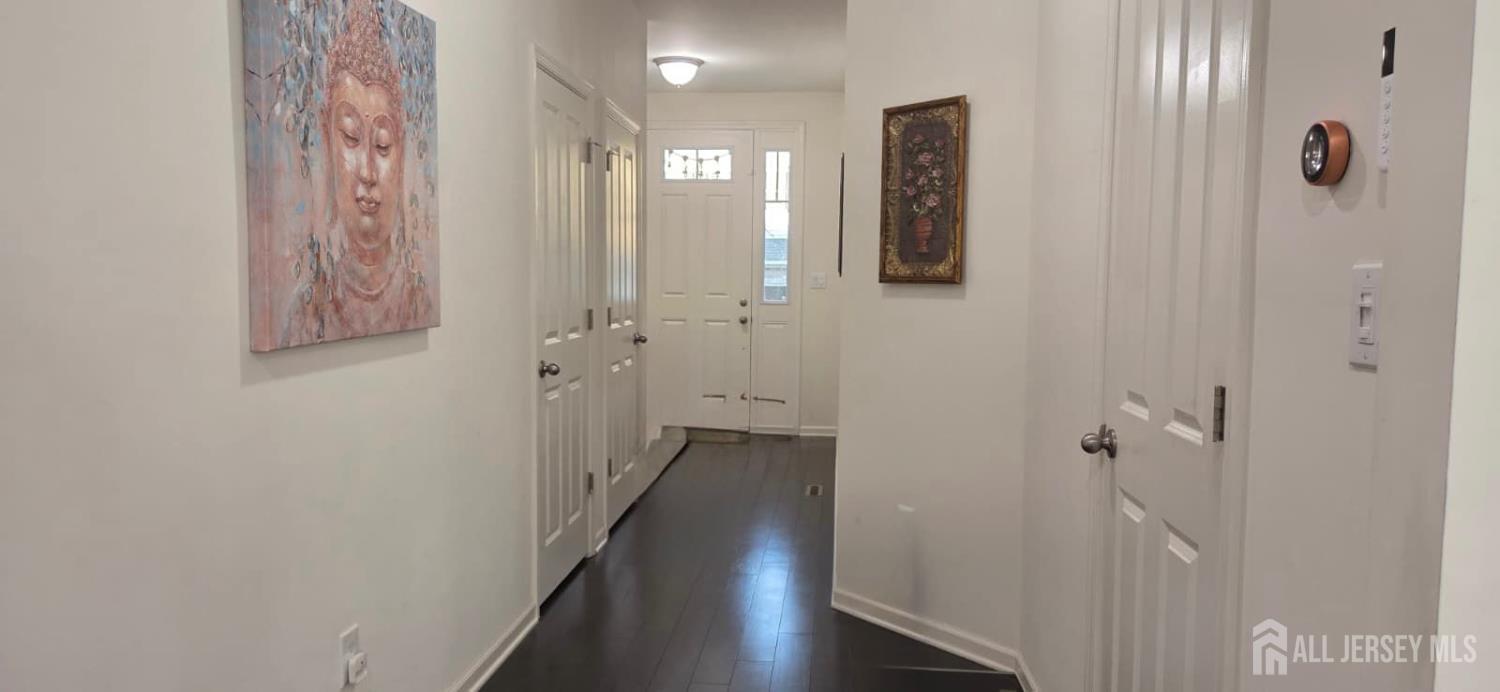 39 Periwinkle Drive, Unit 9 Monroe Township, NJ 08831 - Photo 8 of 26 a view of a hallway with wooden floor and closet area
