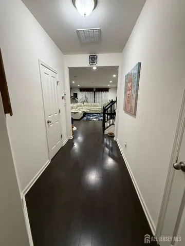 workspace with wooden floor windows and a chandelier