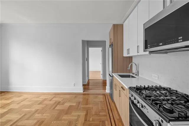 a kitchen with granite countertop a stove and a sink