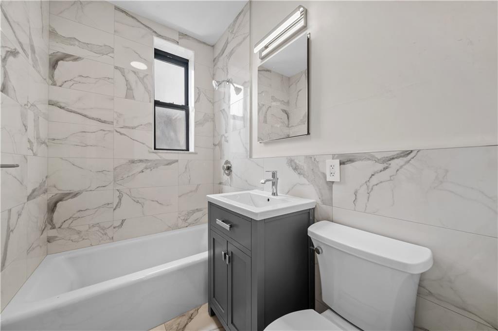 219 78th Street, Unit 3D Brooklyn, NY 11209 - Photo 6 of 10 a bathroom with a sink toilet and shower