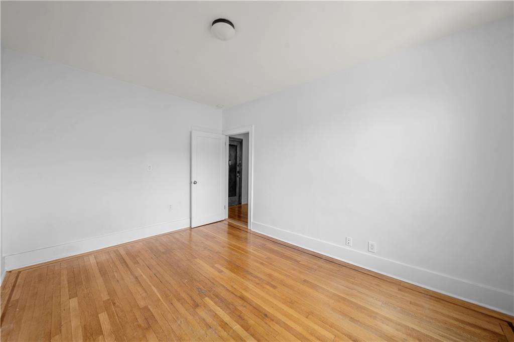 219 78th Street, Unit 3D Brooklyn, NY 11209 - Photo 9 of 10 a view of an empty room with wooden floor