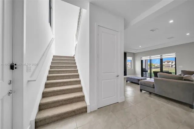 a view of a livingroom with furniture and staircase
