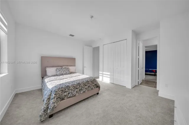 a bedroom with a bed and a cabinets