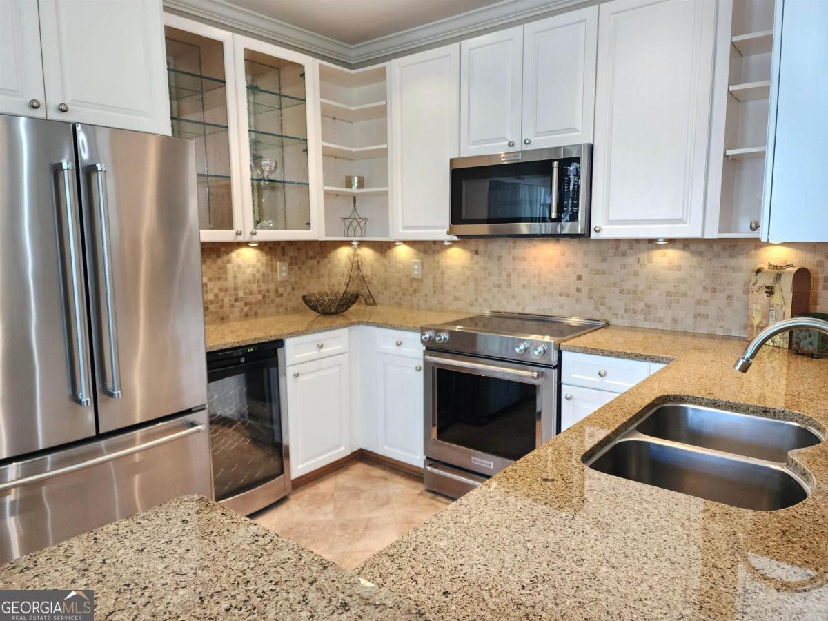 109 (unit 1203) South Bay Road Eatonton, GA 31024 - Photo 16 of 55 a kitchen with granite countertop a sink and a stove top oven