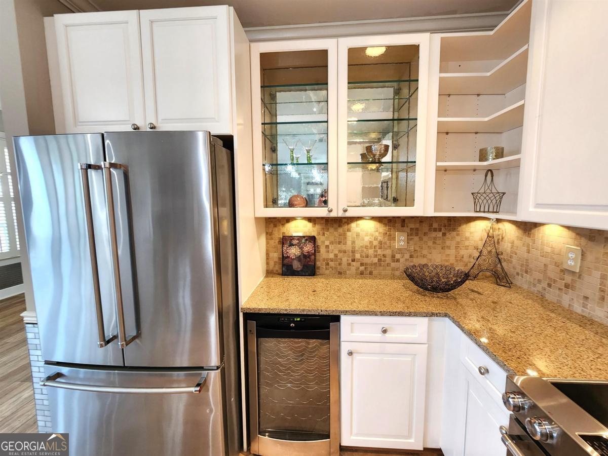 109 (unit 1203) South Bay Road Eatonton, GA 31024 - Photo 18 of 55 a kitchen with kitchen island a counter top space and a refrigerator