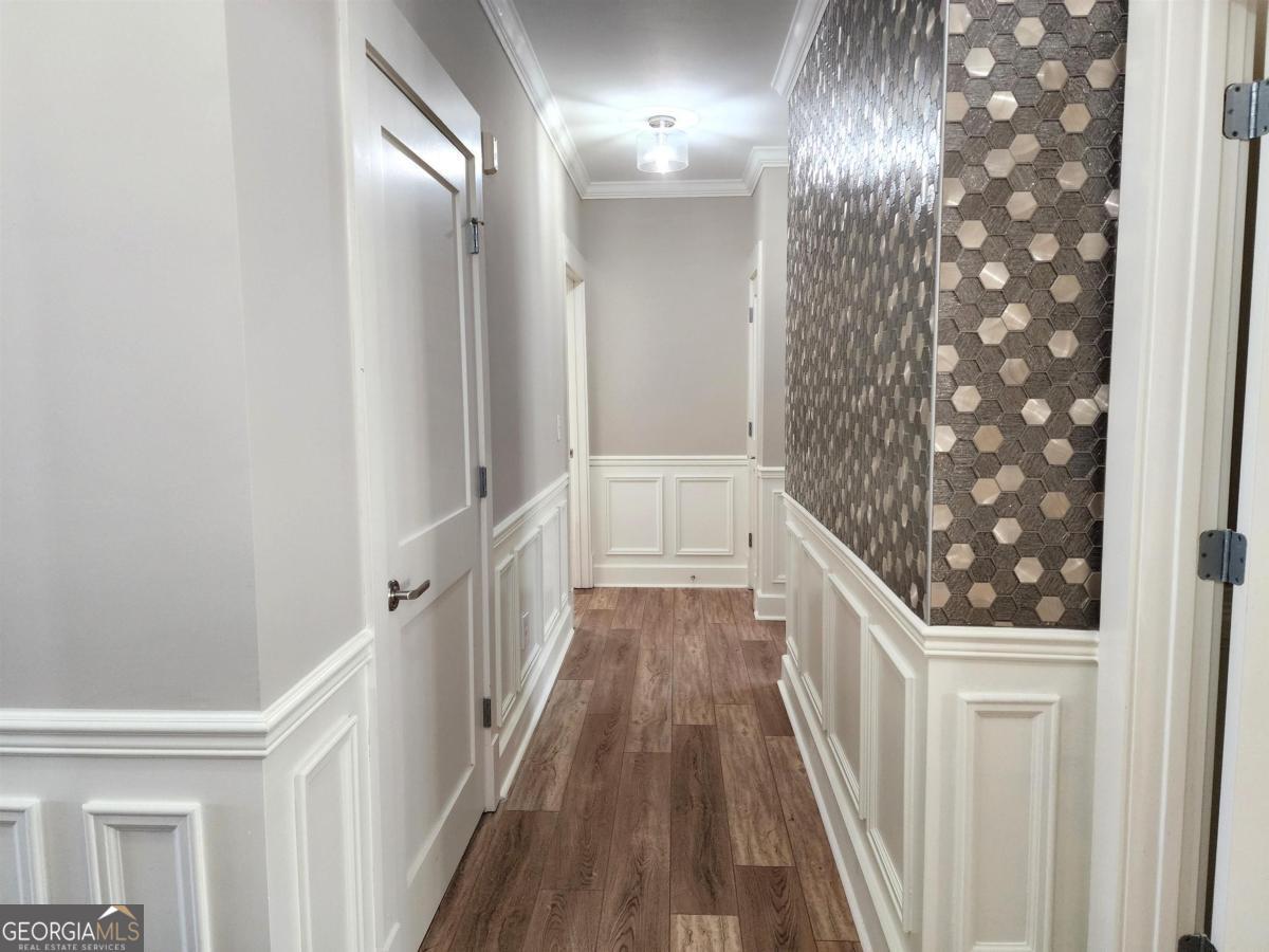 109 (unit 1203) South Bay Road Eatonton, GA 31024 - Photo 21 of 55 a view of a hallway with wooden floor and staircase