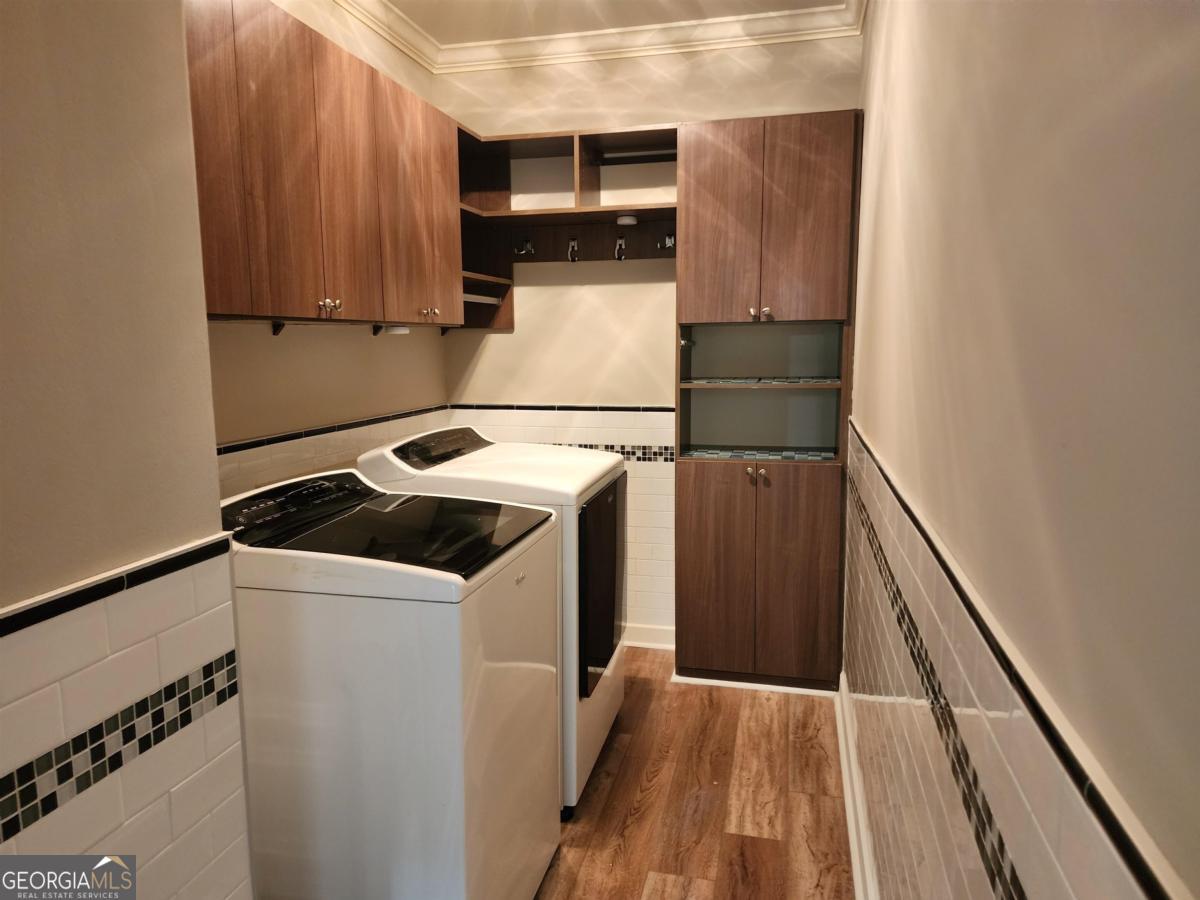 109 (unit 1203) South Bay Road Eatonton, GA 31024 - Photo 22 of 55 a utility room with wooden floor washer and dryer