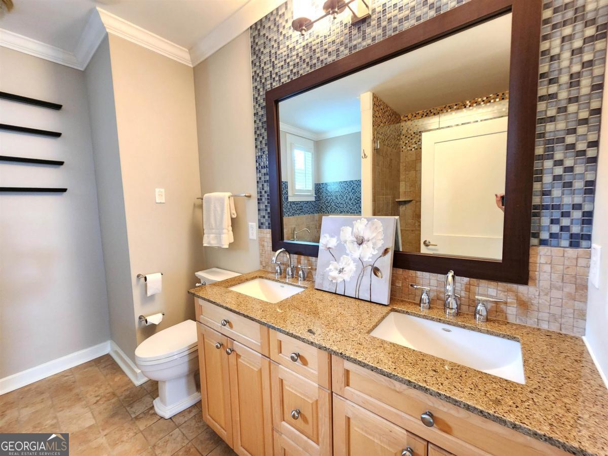 109 (unit 1203) South Bay Road Eatonton, GA 31024 - Photo 26 of 55 a bathroom with a granite countertop sink mirror vanity and toilet