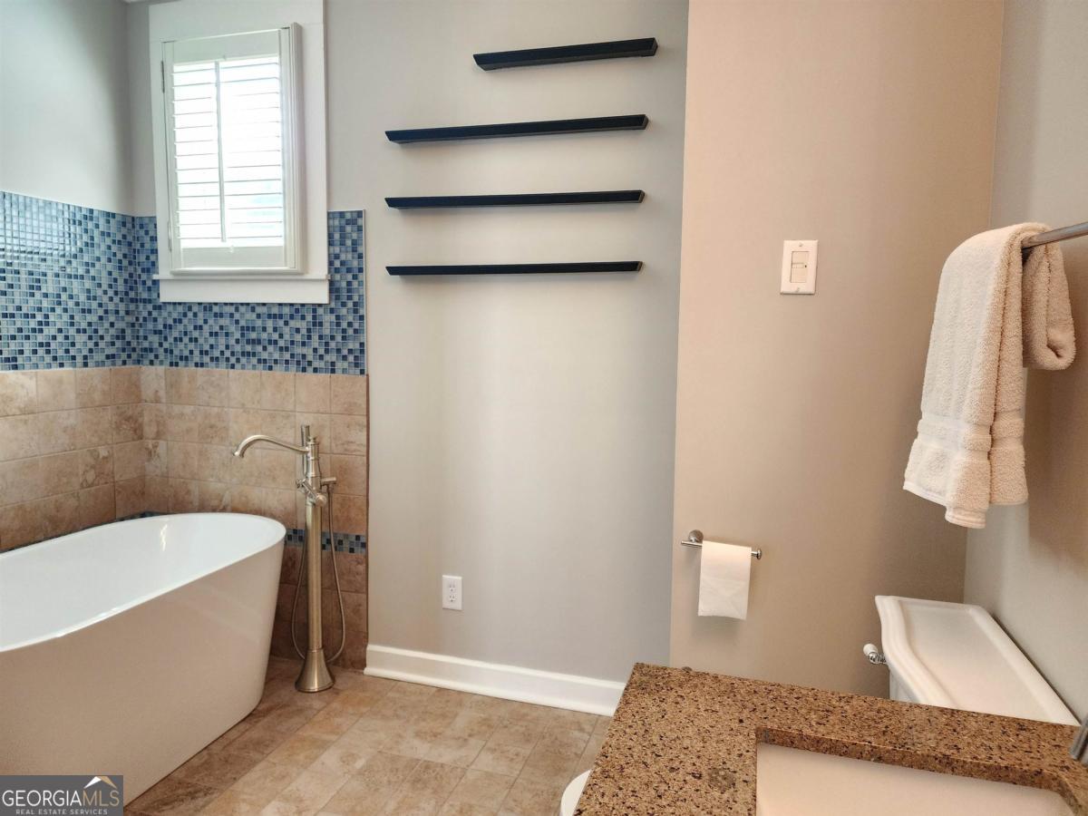 109 (unit 1203) South Bay Road Eatonton, GA 31024 - Photo 28 of 55 a bathroom with a bathtub and window