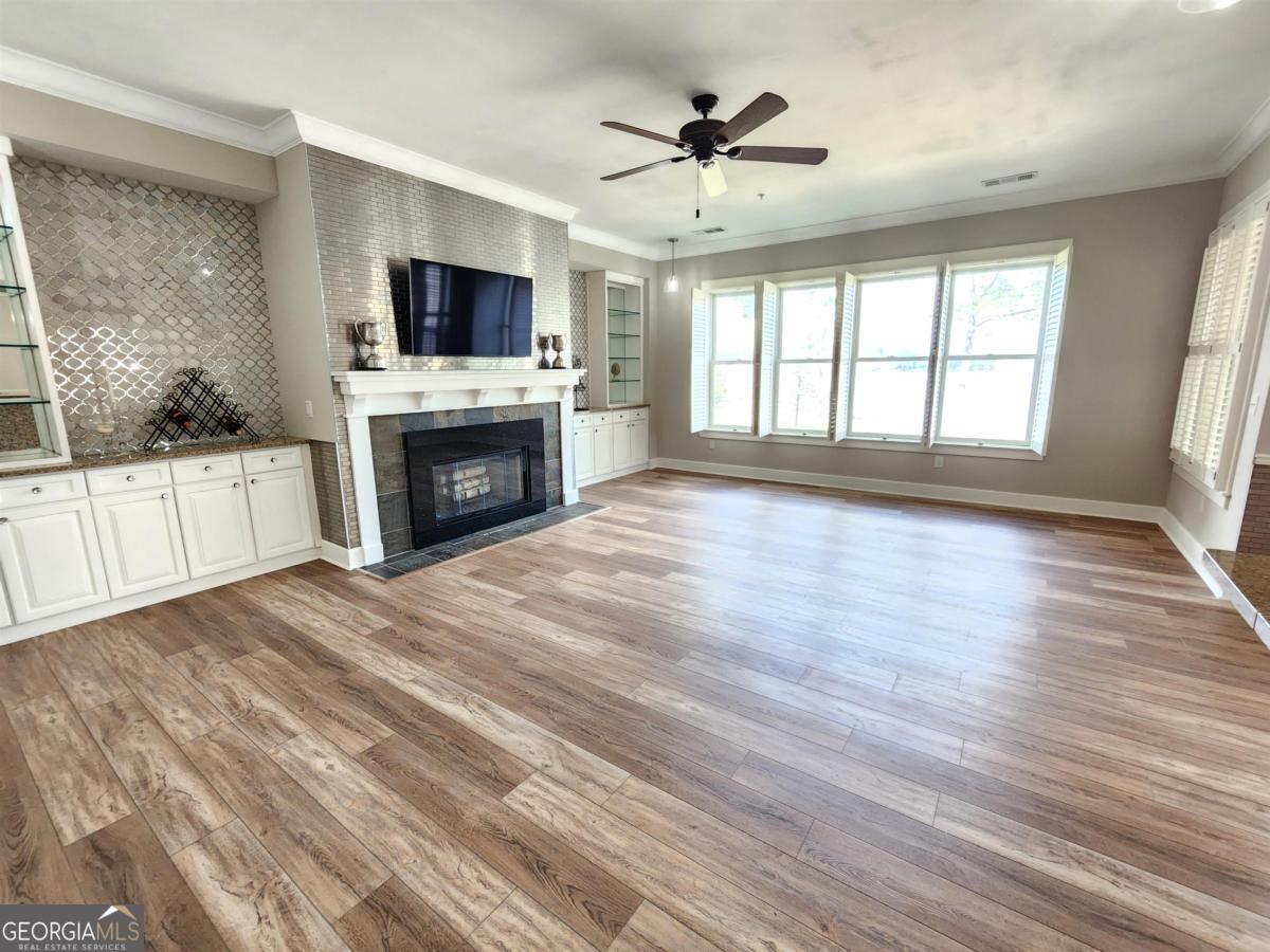 109 (unit 1203) South Bay Road Eatonton, GA 31024 - Photo 3 of 55 a view of a livingroom with a fireplace a ceiling fan and windows