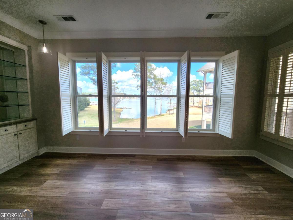 109 (unit 1203) South Bay Road Eatonton, GA 31024 - Photo 39 of 55 a view of an empty room with wooden floor and a window