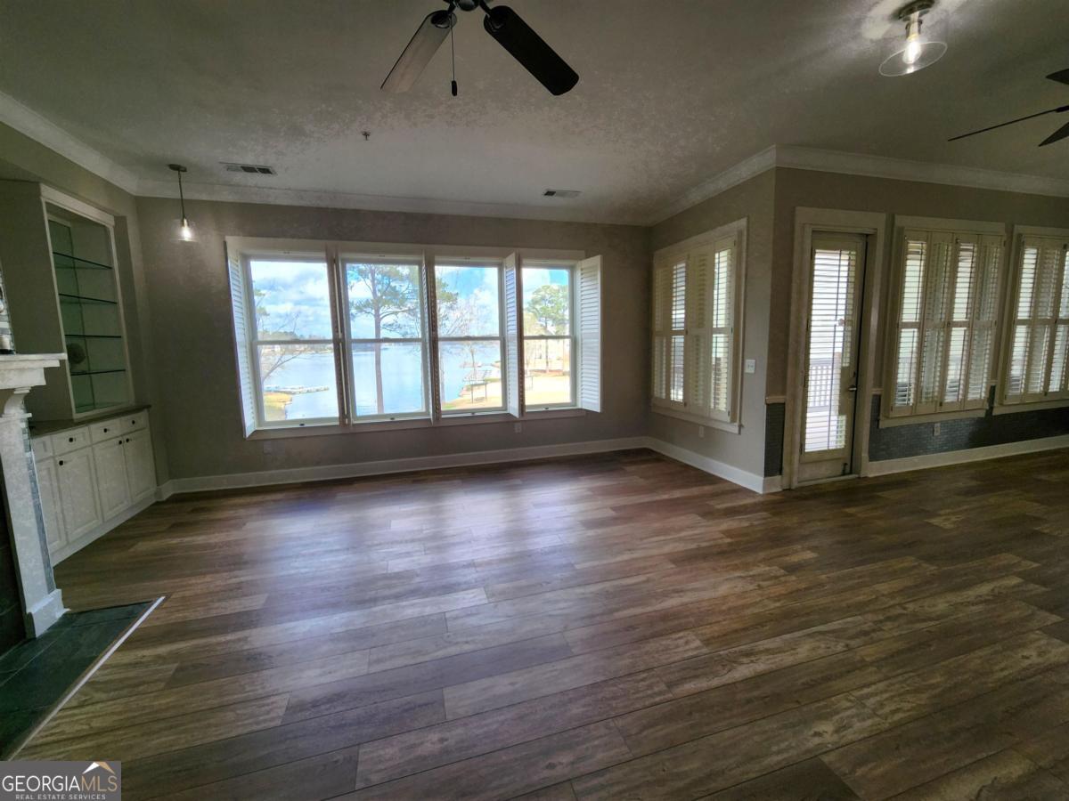 109 (unit 1203) South Bay Road Eatonton, GA 31024 - Photo 40 of 55 a view of an empty room with window and wooden floor