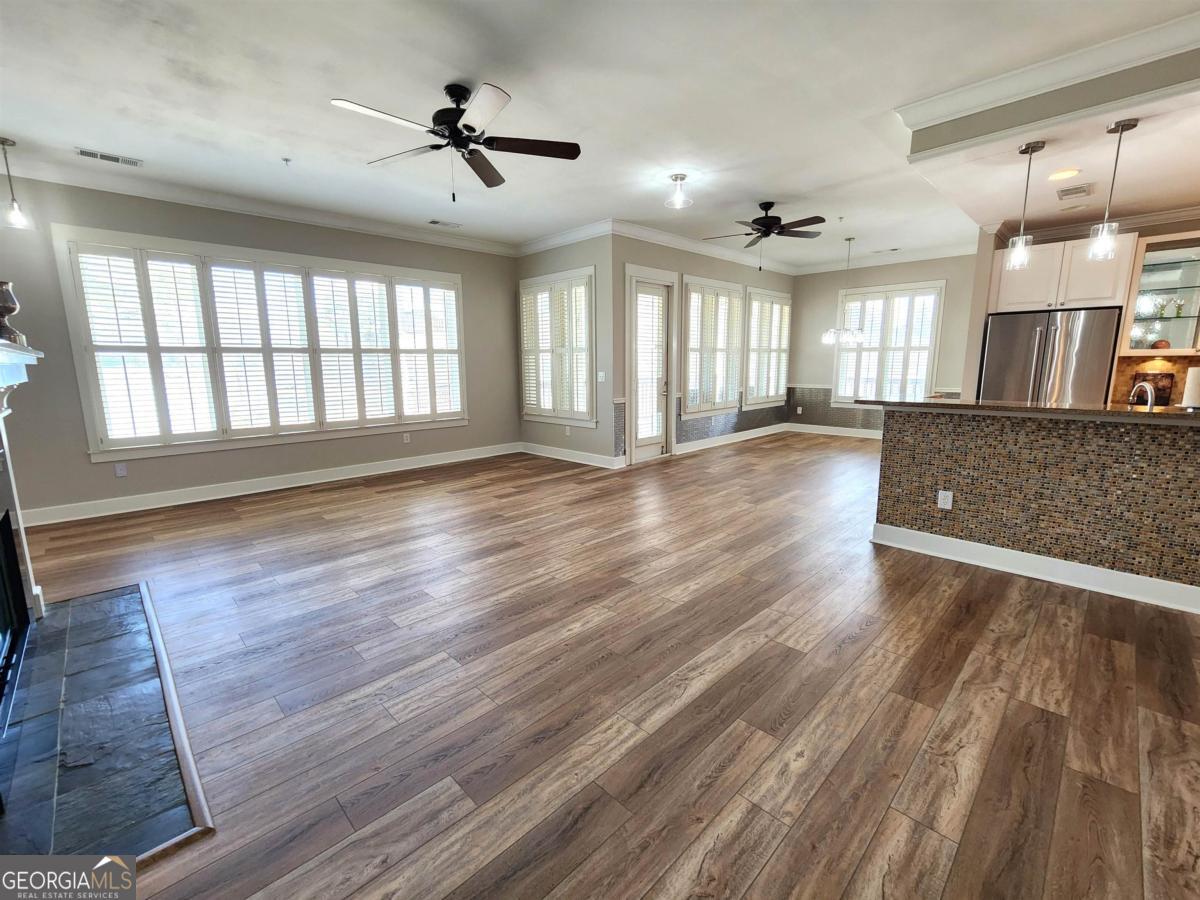 109 (unit 1203) South Bay Road Eatonton, GA 31024 - Photo 4 of 55 an empty room with wooden floor and windows