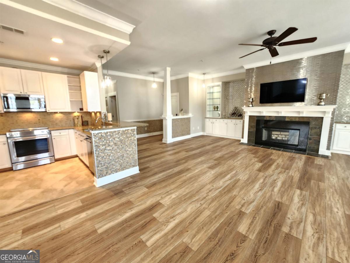 109 (unit 1203) South Bay Road Eatonton, GA 31024 - Photo 6 of 55 a living room with fireplace furniture and a flat screen tv