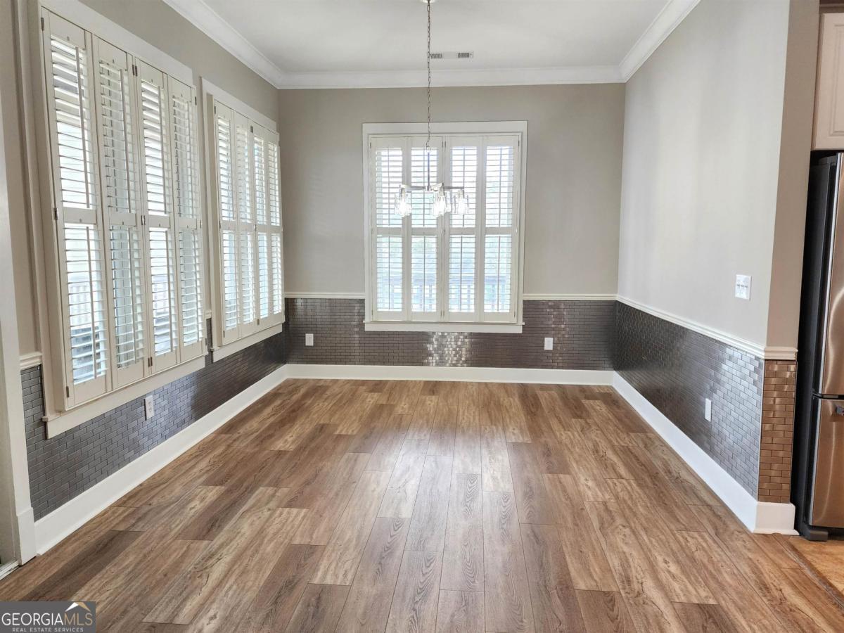 109 (unit 1203) South Bay Road Eatonton, GA 31024 - Photo 8 of 55 a view of an empty room with wooden floor and a window