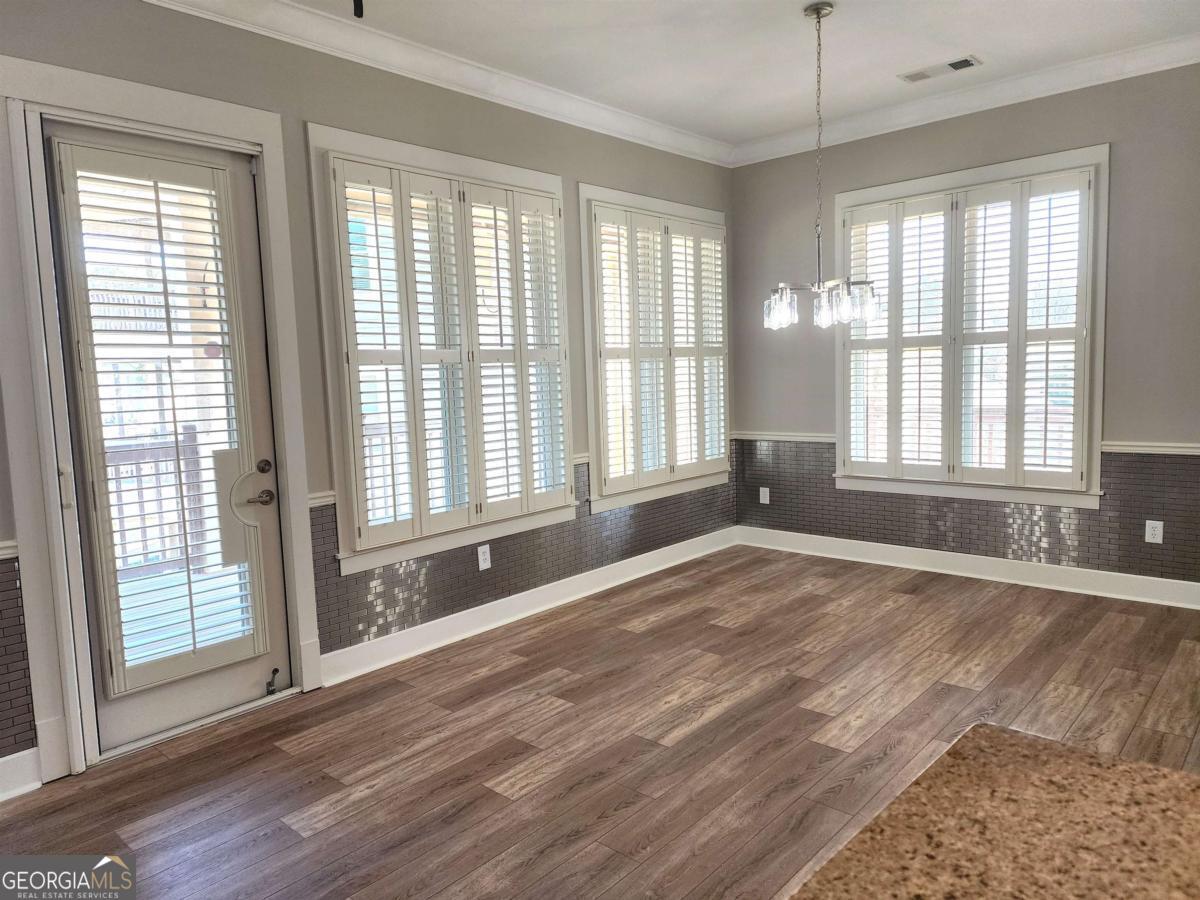109 (unit 1203) South Bay Road Eatonton, GA 31024 - Photo 9 of 55 a view of an empty room with a window and wooden floor
