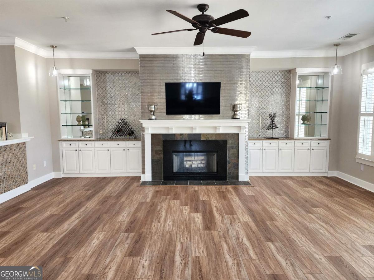 109 (unit 1203) South Bay Road Eatonton, GA 31024 - Photo 10 of 55 a view of empty room with wooden floor and fireplace