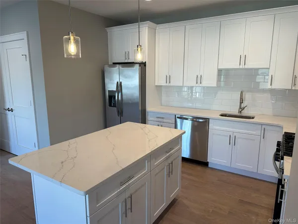 a kitchen with a sink a stove and refrigerator