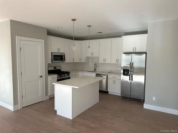 a kitchen with cabinets and stainless steel appliances