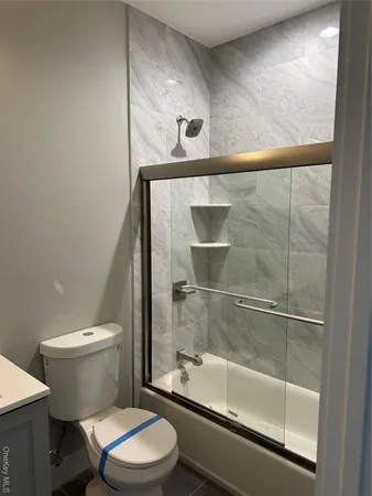 a bathroom with a toilet and a shower