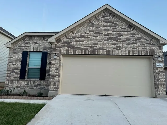 a view of a door in front of a house with a yard