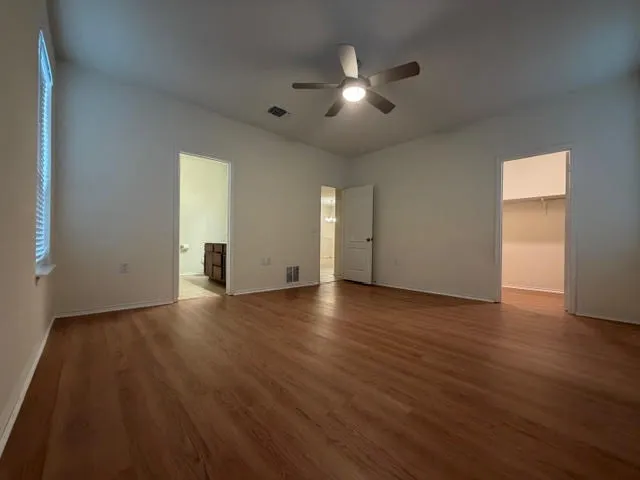 a kitchen with granite countertop kitchen island stainless steel appliances a sink refrigerator and microwave