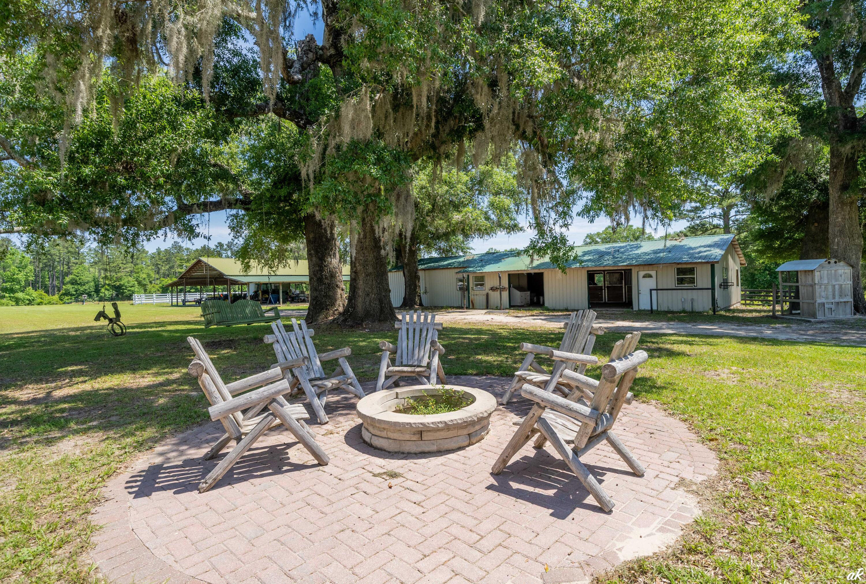 2513 Highway 79 Vernon, FL 32462 - Photo 48 of 85 a view of a swimming pool with a table and chairs in a yard