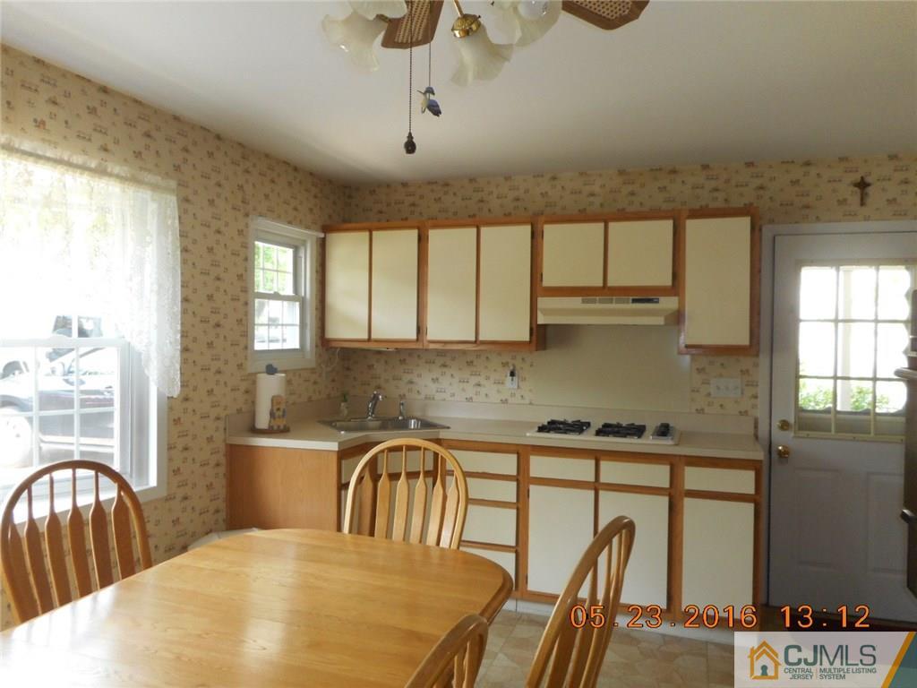 160 Princeton Road Old Bridge, NJ 08859 - Photo 3 of 21 a kitchen with stainless steel appliances granite countertop a sink a stove cabinets dining table and chairs