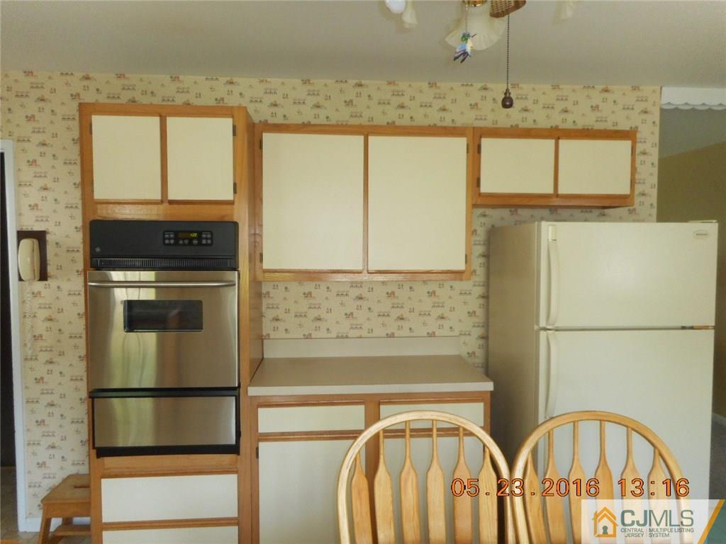 160 Princeton Road Old Bridge, NJ 08859 - Photo 5 of 21 a kitchen with stainless steel appliances granite countertop a refrigerator a stove and a sink with wooden floor