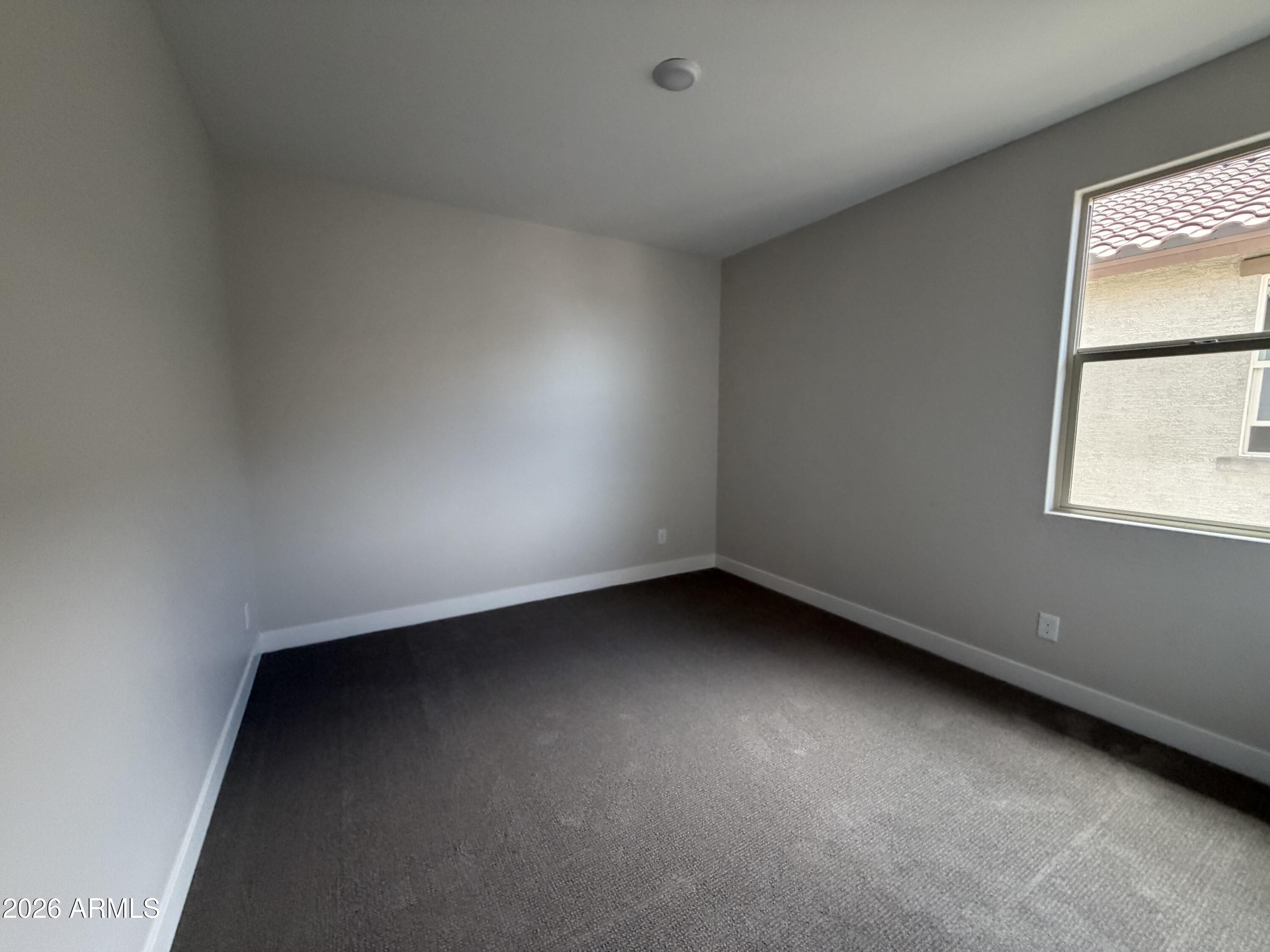 15767 West Sand Hills Road Surprise, AZ 85387 - Photo 26 of 60 an empty room with a window