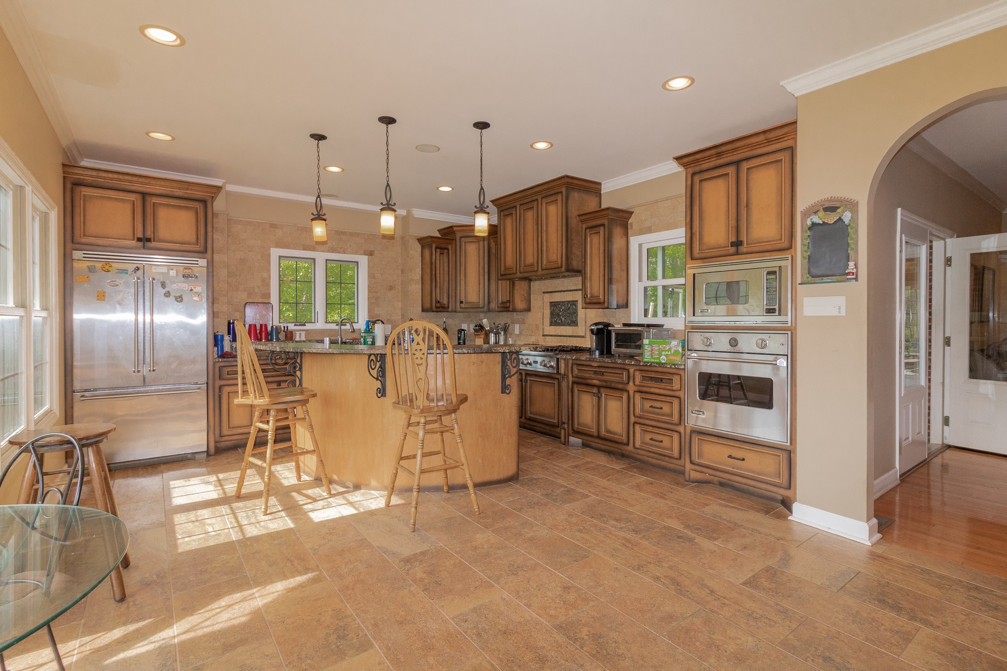 2654 Henry Gower Road Pleasant View, TN 37146 - Photo 18 of 49 a kitchen with stainless steel appliances kitchen island granite countertop a refrigerator a stove a oven and white cabinets with wooden floor