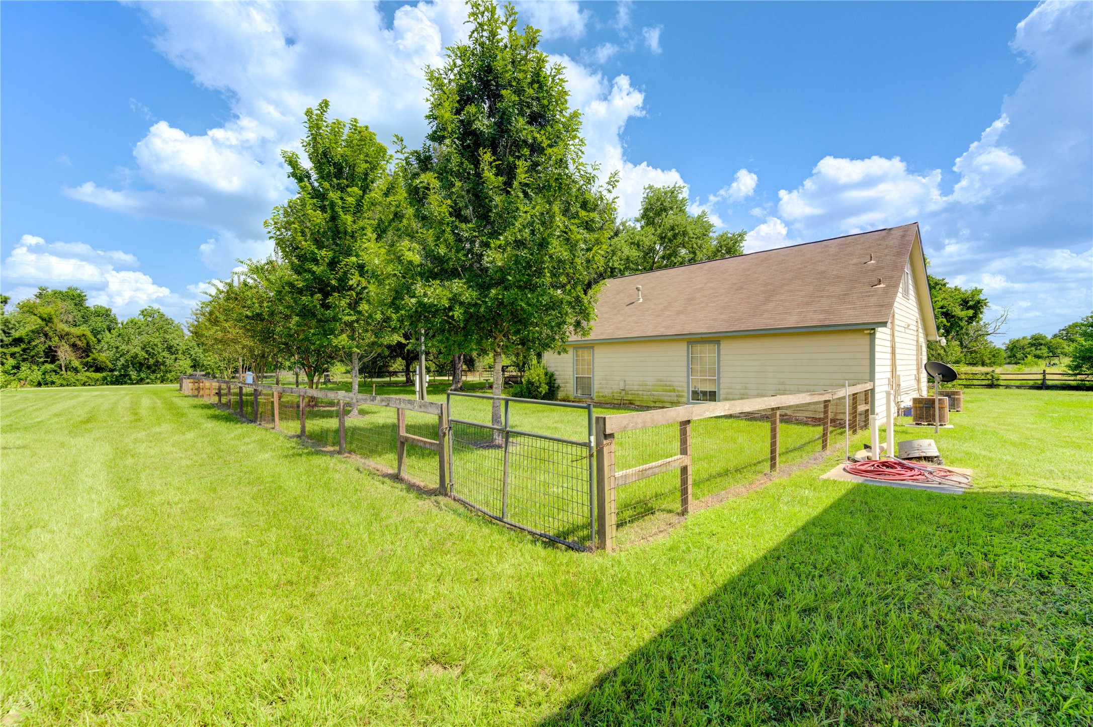 922 Agg Road Tomball, TX 77375 - Photo 7 of 15 a view of an house with swimming pool lawn chairs and a yard